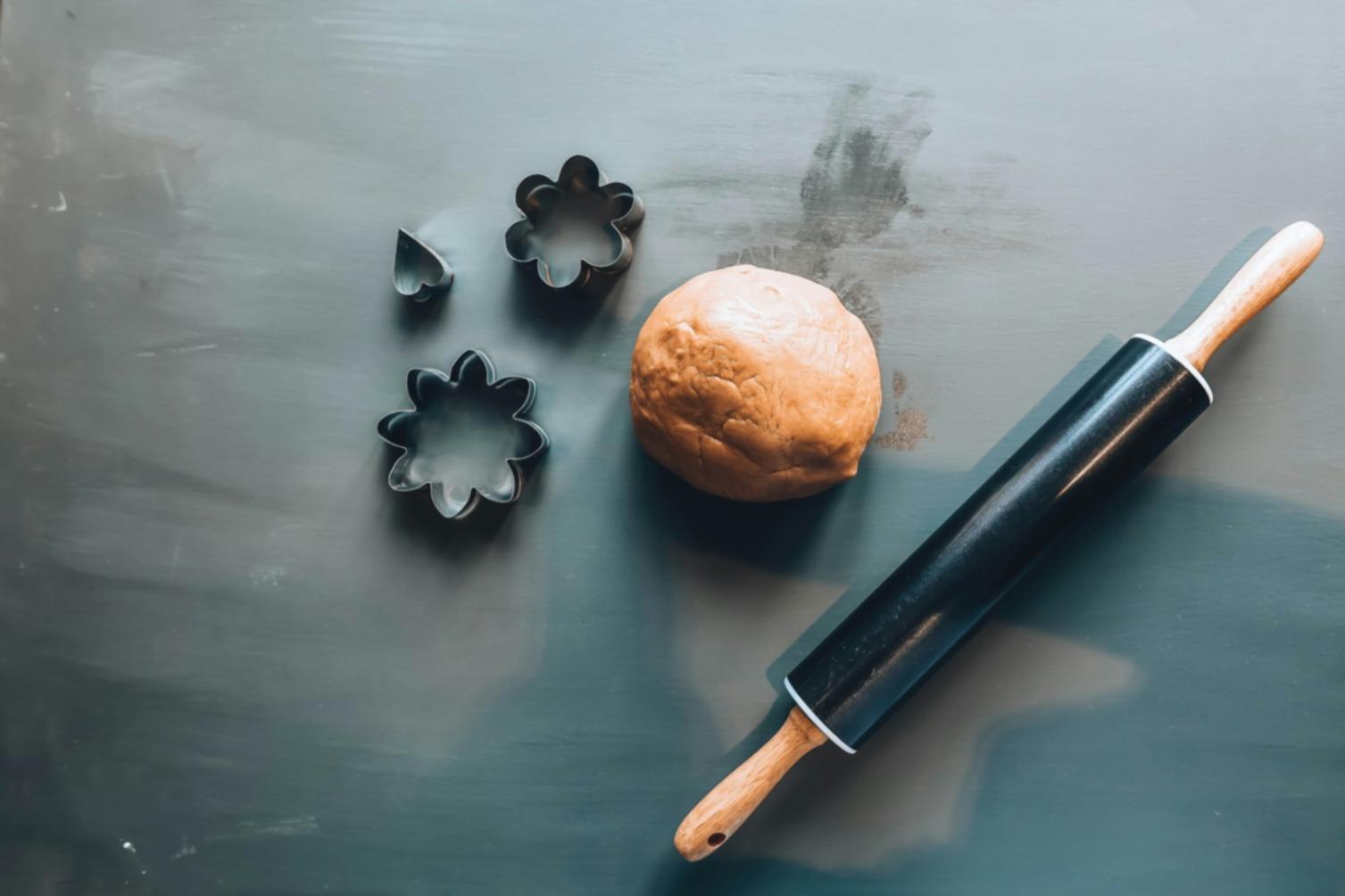 Students practicing dough stretching technique in professional kitchen